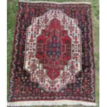 A Persian Bidjar rug with a radiating central lozenge of stylised flowers, 97cm x 77cm approx