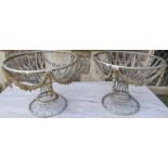 A pair of decorative painted steel circular baskets with decorative repeating floral swag detail, 40