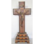 A wooden crucifix with a bronze figure of Christ, raised on a stepped base.50cm high.