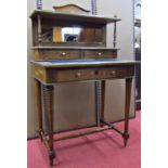 A late 19th century Bonheur de Jour in rosewood, the framework brass banded, fitted with a series of