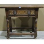 A reproduction oak side table, with rectangular top over a frieze drawer with carved detail,
