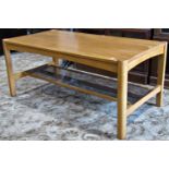 A contemporary Ercol light oak occasional table of rectangular form raised on square cut and moulded