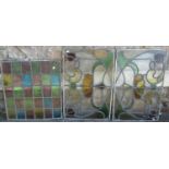 A pair of Art Nouveau style rectangular leaded light glass panels with scrolling organic detail,