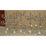 Twelve silver plated candelabra of varying sizes