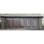 An antique oak overmantle panel, five rectangular fielded panels set within a moulded framework with