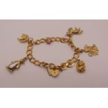 9ct curb link charm bracelet with heart padlock clasp, hung with six novelty charms to include a