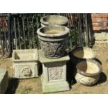 A pair of weathered cast composition stone square cut and stepped pedestals with repeating grape and