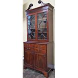 A Georgian mahogany secretaire bookcase, the lower section enclosed by a pair of panelled doors, the