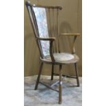 An Edwardian stained beechwood stickback open elbow chair with circular upholstered pad seat and