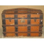 A 19th century timber lathe bound and steel banded domed topped travelling trunk with stitched