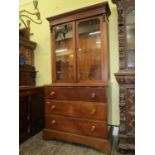 A simple 19th century secretarie bookcase in oak, the lower section fitted with three drawers, the