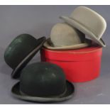 Four bowler hats including 2 black and a grey by Christy's, together with a red hat box (5)