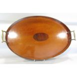 An Edwardian oval mahogany tray with a raised edge and brass handles. 48.5 cm wide.