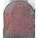 A heavy cast iron fire back of arched form with lion, unicorn, armorial shield relief detail, 54