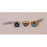 Three 9ct blue topaz rings of various design, to include two trillion-cut examples set with London