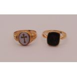 Two 9ct intaglio-cut seal rings; a late Victorian agate cross example and an onyx example
