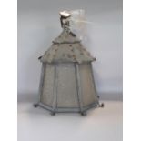 An Arts and Crafts lantern with a tiled pagoda shaped top over eight crackle glazed panes of glass