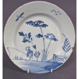 A tin glazed plate with fishermen in landscape, 22cm diameter approx