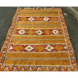 A Dhurri rug both flat woven and knotted pile, with brightly coloured overall geometric pattern,