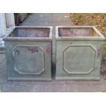 A pair of light green painted simulated lead (fibreglass) square planters with repeating geometric