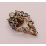 Belle Époque sapphire and diamond clip brooch with white metal millegrain setting, largest diamond