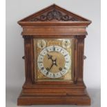 A 19th century German bracket clock, the oak case of architectural form with column support