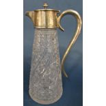 A Victorian cut glass claret jug with silver mounts and scrolled handle bearing the inscription '