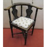 A mid-Victorian period Gothic revival corner chair with carved detail and drop in seat, the top rail