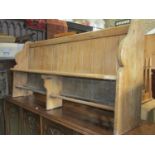 A pitch pine church pew with shaped ends, tongue and groove panelled back with plank seat, 188 cm