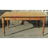 A Victorian partially stripped pine farmhouse kitchen table of rectangular form with boarded top