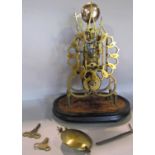 A late 19th century single train brass skeleton clock with gothic detail, striking on a bell, on