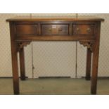 A good quality reproduction oak side table with distressed finish, fitted with three frieze drawers,