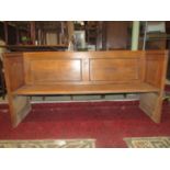 A vintage oak pew, with fielded panelled ends and plank seat, 174cm long x 51cm deep x 86cm high