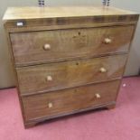 A small mahogany 19th century caddy top chest of three long drawers, with rosewood crossbanding,