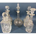 Five 19th century glass decanters of varying design, all complete with the original stopper.