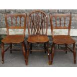 A pair of 19th Windsor kitchen chairs, unusual model with turned spindle backs over addle shaped