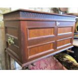 A walnut coffer with rectangular moulded panelled surround beneath a hinged lid with repeating