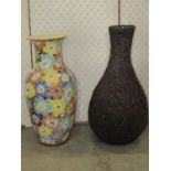 A glazed ceramic oviform vase with decorative flower head detail, 56 cm high together with a further