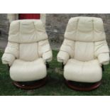 A pair of Ekorness Stressless lounge chairs with cream soft leather stitched upholstery