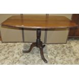 An oak snaptop occasional table, the rectangular top with curved and moulded outline raised on a