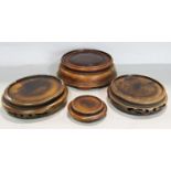 Four Chinese hardwood vase stands of varying diameters