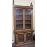 A good quality Victorian walnut country house library bookcase, the upper section enclosed by two