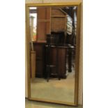A contemporary wall mirror of rectangular form with bevelled edge plate within a gilt stepped and