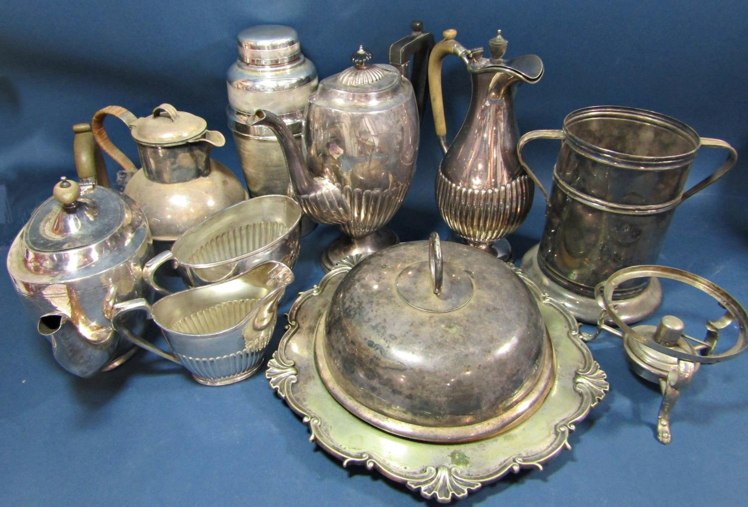 A mixed selection of silver plated items including a cocktail shaker, wine cooler, tureen, tea and