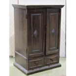 A small 1920s Jacobean revival oak wall cabinet in the form of a wardrobe enclosed by a pair of