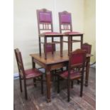 An arts and crafts oak dining table raised on square cut and tapering supports united by moulded and