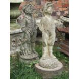 Two weathered cast composition stone garden ornaments in the form of standing boy figures, 70 cm