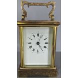 An English carriage clock, the case with chased detail, enclosing an eight day time piece