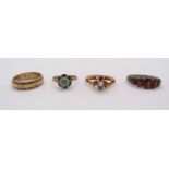 Four gem set rings comprising a 9ct opal and ruby example, a further 9ct example, yellow metal