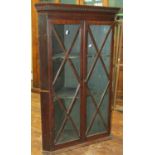 Georgian mahogany hanging corner cupboard with astragal glazed panelled doors enclosing a fitted and